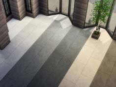 an aerial view of a room with windows and a potted plant on the floor