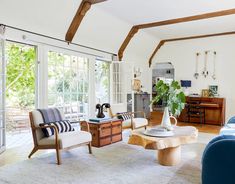 a living room filled with furniture and lots of windows