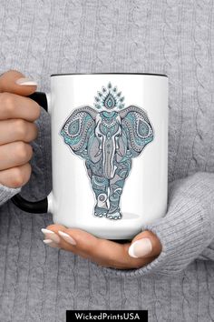 a woman holding a coffee mug with an elephant design on the front and side, in her hands