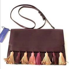 This Chic Fold-Over Style Envelope Clutch Is Made Of Soft-Yet-Structured Leather, So It Keeps Its Shape And Looks Great Tucked Under Your Arm Or Worn Crossbody Burgundy Red Leather Front Flap Trimmed In Multi Colored Tassels. Back Slip Pocket Back Logo Plaque Gunmetal Hardware Removable Cross-Body Strap Magnetic Closure Fabric Lining 6 Interior Card Slip Pockets 11.5 W X 8"H X 1"D Strap; 22" Drop. New With Tags Chic Clutch Shoulder Bag With Tassels, Chic Tassel Clutch Shoulder Bag, Evening Crossbody Bag With Tassels, Leather Party Bags With Tassels, Gunmetal Hardware, Envelope Clutch, Burgundy Red, Magnetic Closure, Rebecca Minkoff