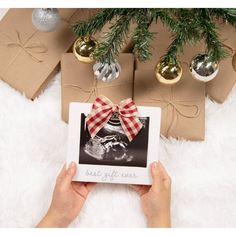 a person holding up an x - ray photo in front of christmas decorations and presents