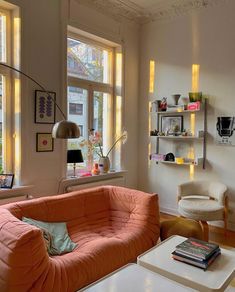 a living room filled with furniture and windows