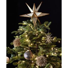 a christmas tree decorated with gold and silver ornaments, including a star ornament