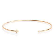 14k gold open cuff bracelet with a white prong set white diamond on one end of the cuff and a bezel set princess diamond on the other end SPECIFICS • cuff wire is approx. 1.5mm wide• total bracelet is approx. 6.4cm wide x 5cm tall• cuff opening is approx. 28mm• white diamonds .11ctw Minimalist Cubic Zirconia Bangle Jewelry, Formal Single Diamond Bangle Jewelry, Formal Single Diamond Bangle, Adjustable Diamond Bangle In Fine Jewelry, Adjustable Diamond Bangle Fine Jewelry, Fine Jewelry Cuff Bracelet With Brilliant Cut For Gift, Fine Jewelry Single Diamond Bangle, Fine Jewelry Bangle Bracelet With Single Diamond, Dainty Single Diamond Bangle Jewelry