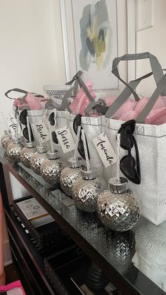 several bags and sunglasses are lined up on a shelf