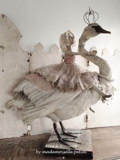 a statue of a woman in a dress with two geese