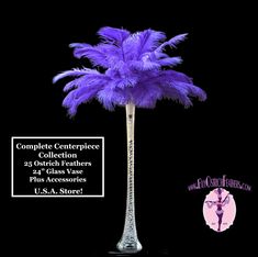 a tall glass vase with a purple feather tree in it's centerpieces