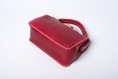 "*DOCTOR BAG'S HANDMADE VIDEO* https://youtu.be/QpdhSCjh2BM Product Description * Material: vegetable tanned leather * Color: Hand-dyeing red * Flap over entry with buckle closure ,a rounded projection on the, please press it up to open the flap * 0.75\" wide leather shoulder strap : 110cm * Sewn by hand; * Size: 140mm (H) x 170mm (W) x 70mm (D) / 5.5\" x 6.7\" x 2.7\" Please first look at the production process of our product. 1. The vegetable tanned leather is made in Italy: Vegetable tanning Red Rectangular Leather Box Bag, Red Leather Rectangular Box Bag, Leather Box Bag Suitable As A Gift, Leather Handbags Handmade, Biker Wallet, Side Bag, Doctor Bag, Short Wallet, Side Bags