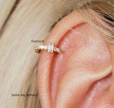 a woman's ear is shown with three different types of piercings