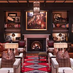 a living room filled with furniture and a fire place in the middle of it's walls