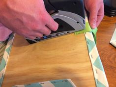 a person using a sanding machine on top of a wooden table