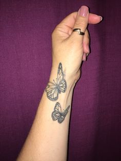 a woman's arm with two butterflies on it