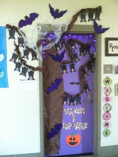 a door decorated with halloween decorations and bats