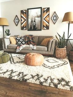 a living room filled with lots of furniture and pictures on the wall above it's couch