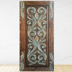 an ornate wooden panel with blue swirls on it