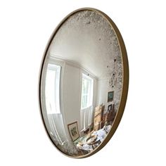 an oval mirror reflecting the inside of a room