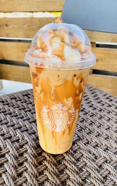 a starbucks drink sitting on top of a table