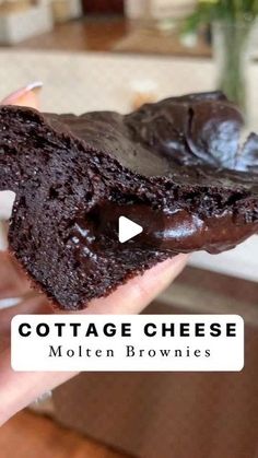 a person holding a piece of chocolate cheese brownie in their hand with the words cottage cheese written on it