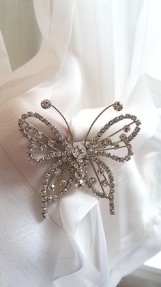 "Dazzling rhinestone butterfly brooch in a nice large size. This pin is unusual with the outline of the butterfly done in sparkling rhinestones. It has wonderful antennas with a rhinestone at the tips. The clear colorless rhinestones and outline design make this a classic. The metal is a silvertone and the pin has a rollover safety catch on the reverse. Condition is good and this is a very well made piece of jewelry.  Similar in construction to designs by Juliana. measurements are 2 3/4\" by 2 3 Silver Butterfly Brooch For Wedding, Silver Butterfly Brooch For Party, Butterfly Outline, Outline Designs, Butterfly Brooch, Antennas, Silver Brooch, Divine Feminine, Vintage Rhinestone