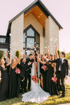 a group of people that are standing in front of a building with some confetti