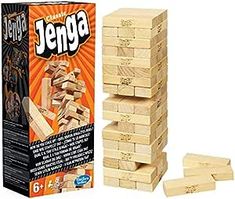 a stack of wooden blocks sitting next to a box of jergga on a white background