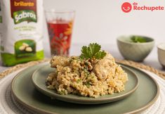 a plate with rice and meat on it next to a bag of broccoli