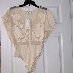 Ivory Bodysuit With Lace Detail. Sheer White Bodysuit For Spring, Spring Sheer White Bodysuit, Elegant Spring Bodysuit With Lined Body, Chic Beige Lined Bodysuit, Chic Sheer Bodysuit For Spring, Chic Beige Bodysuit For Spring, Fitted Beige Bodysuit For Summer, Fitted Cream Bodysuit With Lined Body, Cream Fitted Bodysuit With Lined Body