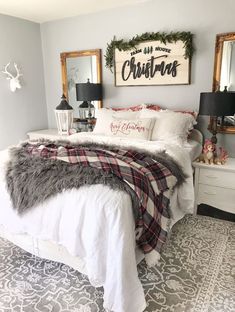 a white bed sitting in a bedroom next to two framed pictures on the wall above it