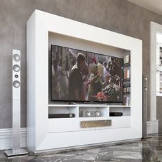 an entertainment center with a large television and speakers