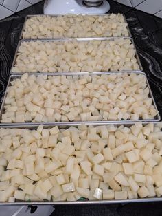 three pans filled with food sitting on top of a counter