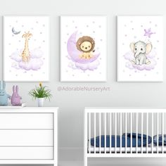 a baby's nursery room with three pictures on the wall