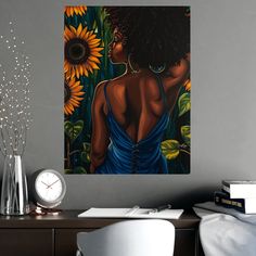 a painting of a woman with sunflowers on the wall next to her desk