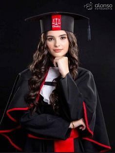 a woman wearing a graduation cap and gown posing for the camera with her hand on her chin