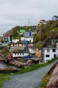 houses on the side of a hill near water