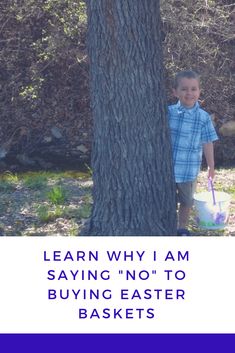 a young boy standing next to a tree with an easter basket in it's hand