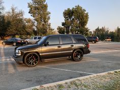 a black suv parked in a parking lot