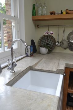 a kitchen counter with a sink and window