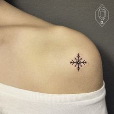 a snowflake tattoo on the left shoulder