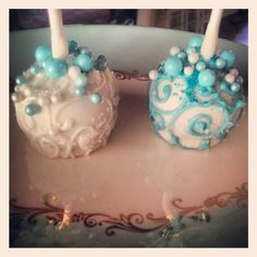 two cake pops decorated with blue and white frosting