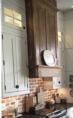 a stove top oven sitting inside of a kitchen next to wooden cabinets and counter tops