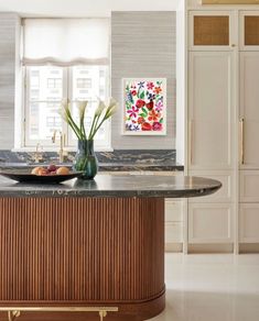 a kitchen with marble counter tops and wooden cabinets