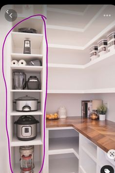 a kitchen with white cabinets and purple lines on the wall next to an open shelf