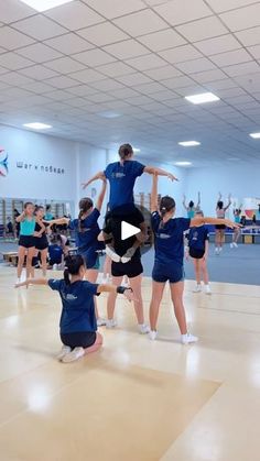 a group of people standing on top of a gym floor in front of an audience