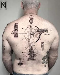 the back of a man's body with many different things on it, including a clock