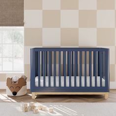 a baby crib in the corner of a room with checkered wall paper on the walls