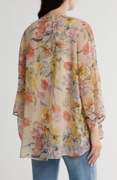 Fall for the flowy fit of this sheer chiffon overlay covered in delightful blooms. 26" length Open front Long sleeves 100% polyester Machine wash, line dry Made in the USA of imported fabric Flowy Chiffon Blouse With Floral Print, Sheer Chiffon Flowy Blouse, Sheer Flowy Chiffon Blouse, Spring Printed Chiffon Blouse, Floral Print Chiffon Blouse For Vacation, Feminine Silk Chiffon Blouse For Spring, Chiffon Floral Print Blouse For The Beach, Bohemian Chiffon Blouse With Floral Print, Spring Sheer Silk Chiffon Blouse