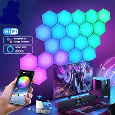 a person holding a smart phone in front of a computer screen with an illuminated hexagonal background