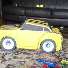 a yellow toy car sitting on top of a rug