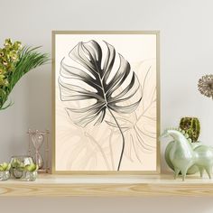 a framed art print on a shelf next to vases and plants