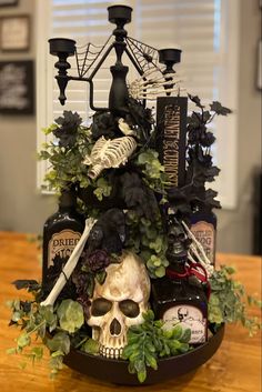 a table topped with lots of halloween decorations and skulls on top of candlesticks